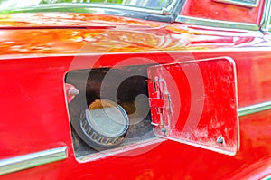 Open fuel tank of a Lada car. Car refueling close-up. Old red car