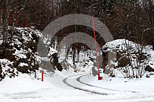 Open gate entrance on snow covered forest road