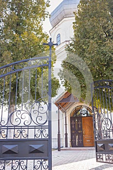 Open gate to the church yard. Doorway to christian church. Ortodox cathedral. Religious architecture. Faith and pray concept.