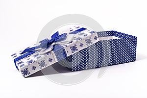Open gift box in blue color with bow on white background