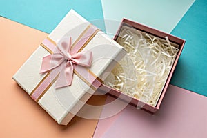 Open gift box on color background, top view
