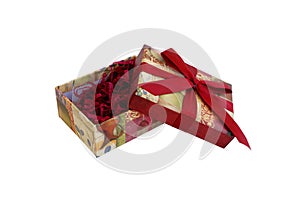 Open gift box with filler and red ribbon