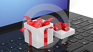 Open gift box full of Christmas balls on laptop