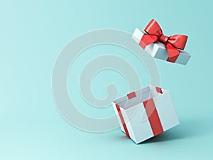 Open gift box or present box with red ribbon and bow isolated on green blue pastel color background