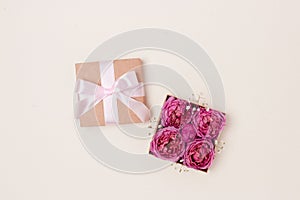 Open gift box with rose flowers inside. Present for Mothers Day.