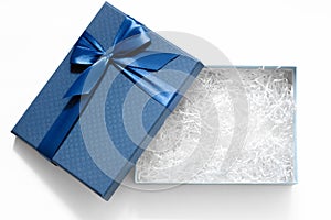 Open gift box with shredded paper on a white background