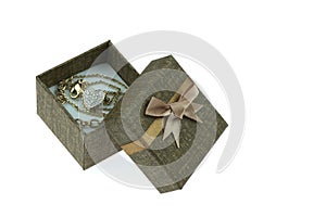 Open gift box ,Which has a heart shaped gold necklace inside isolated on the white background