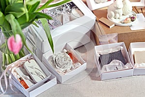 Open gift boxes display an aromatherapy stone accessory and a fragrance bottle, aligning with the themes of relaxation