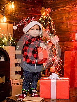 Open gift. Lovely baby enjoy christmas. Santa boy little child celebrate christmas at home. Childhood memories. Boy cute