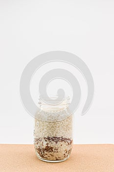 open glass container with white and brown rice
