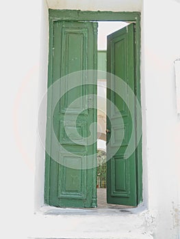 Open green door, Mikonos island photo