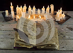 Open Grimoire book with candles