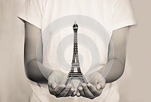 Open hand with a model the Eiffel Tower - tone vintage.