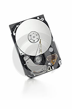 Open hard drive standing on white