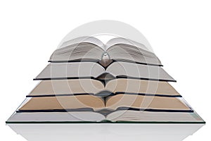 Open hardback books stack on white