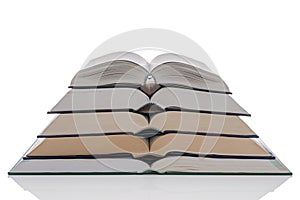 Open hardback books stack on white photo