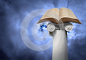 Open holy bible on ancient ionic column pillar post