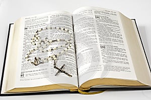 Open holy bible and beads