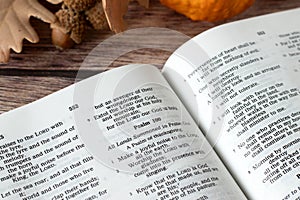 Open holy bible book, psalm 100 verse for thanksgiving and praise to God Jesus Christ on wooden table