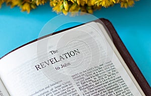 Open Holy Bible on the Book of revelation to apostle John from God and Jesus Christ about end times