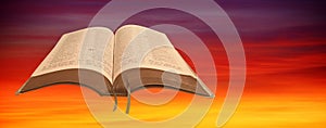 Open holy bible scripture sky background sunset red skies book god jesus christ religion religious prayer pray