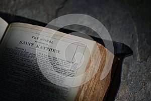 An Open Holy Bible on Stone Table Bckground