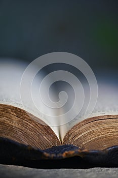 An Open Holy Bible on Stone Table Bckground