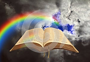Open holy bible word of god rainbow sky clouds storm stormy skies divine heaven light heavenly christ jesus pray prayer gospel photo