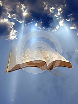 Open holy bible word of god sun rays beam clouds