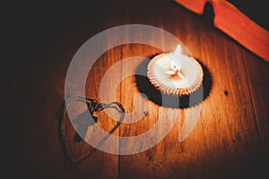 Open Holy and candle on a old oak wooden table. Beautiful gold background.