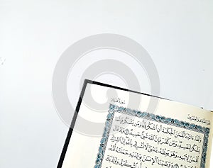 Open Holy Qur'an on a white table