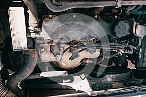 Open hood of the car. View of the engine and vehicle parts. Diagnostics and repair of old car.