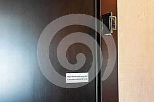 Open hotel deadlock on wooden door from inside of the room