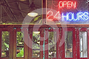 Open 24 hours neon sign on wall