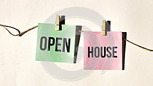 Open,house, text words inscription on yellow sticker note on white wall or table