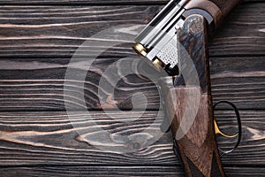 open hunting rifle on a wooden background