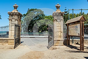 Open iron gate with two stone side columns, entrance to GenovÃ©s park, CÃ¡diz SPAIN photo