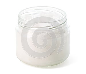 Open jar of coconut oil on white background