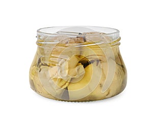 Open jar of delicious artichokes pickled in olive oil isolated on white