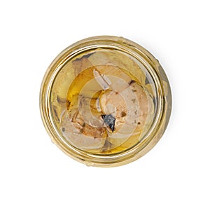 Open jar of delicious artichokes pickled in olive oil isolated on white, top view