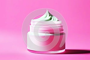 Open jar with white face cream on a pink background. Skin care cosmetics