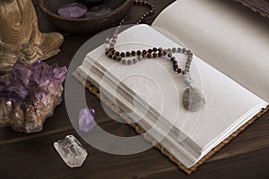 Open Journal or Notebook Surrounded by Crystals on a Wooden Surface photo