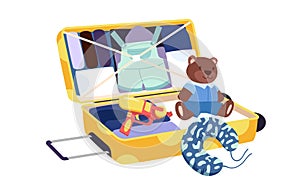 Open kids yellow suitcase with clothes and toys inside, packing teddy bear and water gun