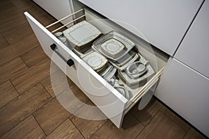 Open kitchen drawer with plates inside, a smart solution for kitchen storage and organizing