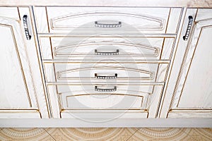 Open kitchen drawer, traditional kitchen. wooden light beige facade. With dark handles and rhinestones on the handles
