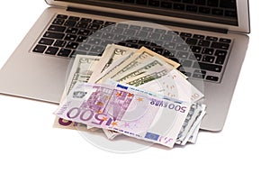 Open Laptop With Dollars And Euro money