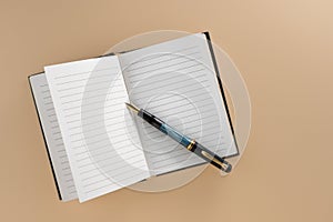 Open lined notebook with old fountain pen
