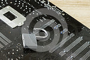 The open lock lies on the computer`s motherboard the concept of information protection data hacking