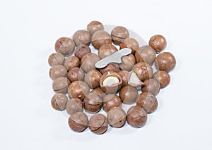 Open Macadamia nut by tool on background