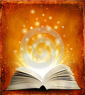Open magic book with lights
